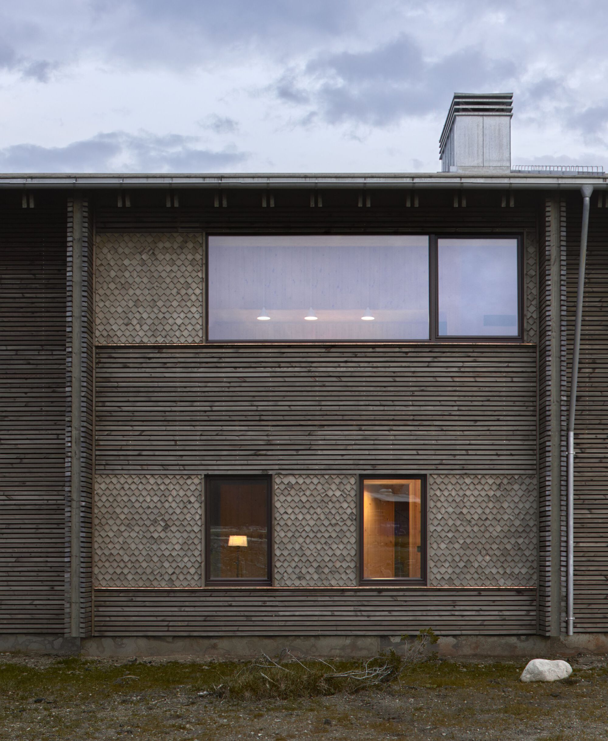 Front detail showing the two cladding patterns meeting at a window bay